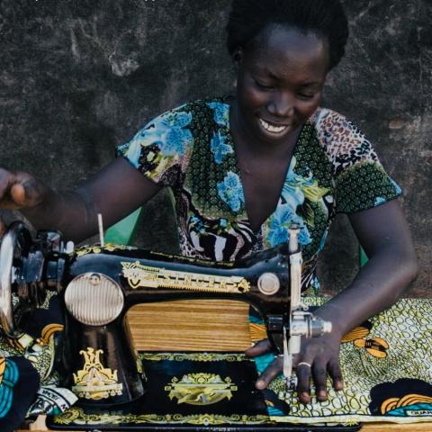 A woman sews at a machine